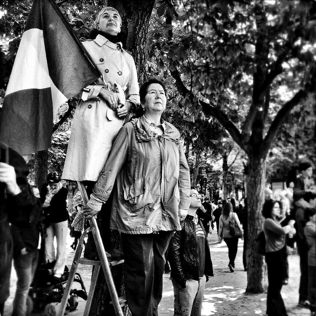 Two women waiting for the 14th July parade on the Champs Elysées